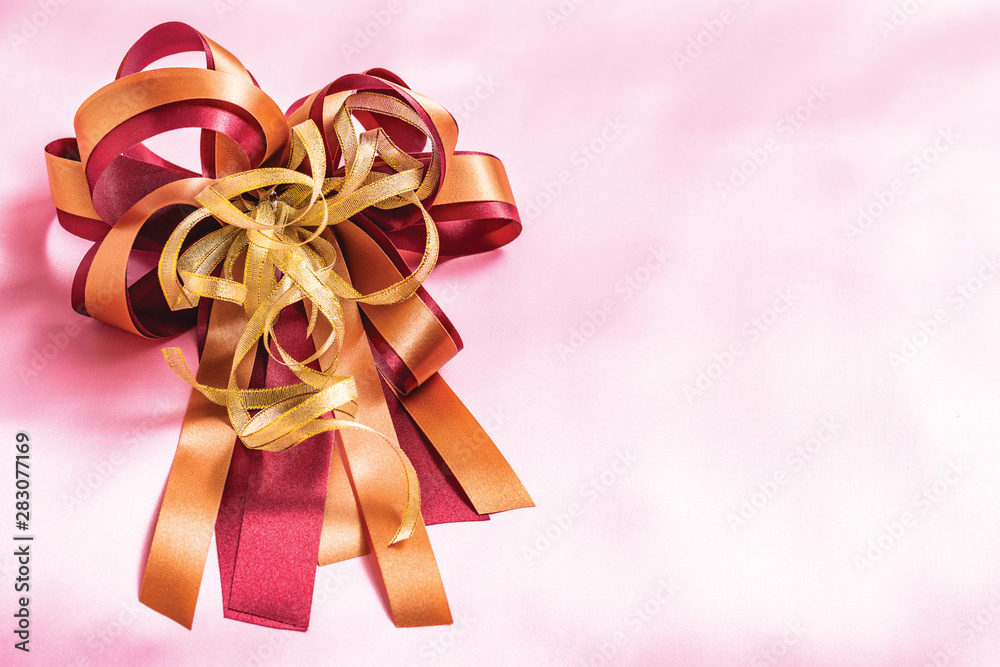 red gift box with ribbon and bow isolated on pink background red gift box with ribbon and bow isolated on pink background