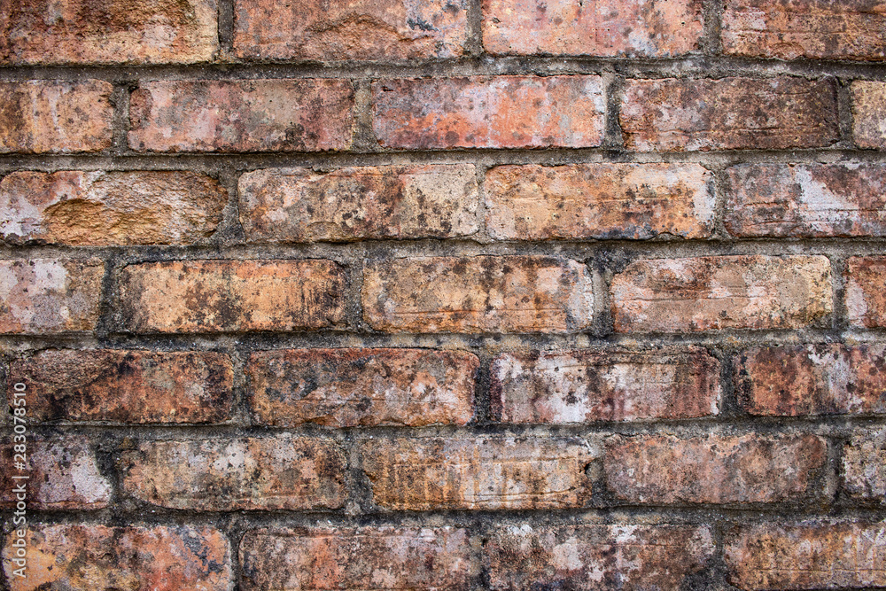 Orange worn grunge brick wall surface background weathered dirty distressed texture Orange worn grunge brick wall surface background weathered dirty distressed texture