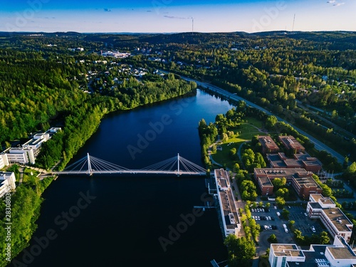 Quadro su tela Aerial view of blue lake with cable-stayed bridge and green summer town in Finland