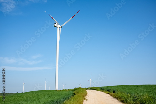 Landscape of Murgia with road heading to a wind farm. Puglia region, Italy