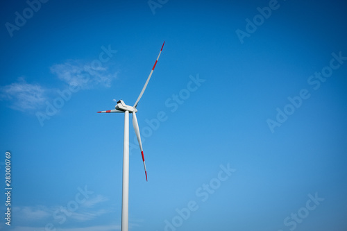 Close up of a wind turbine on a blue sky © effebi77