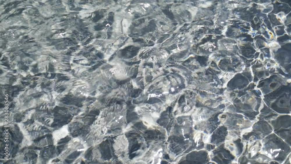 Transparent water in the fountain is illuminated by the sun creating beautiful patterns 4k Transparent water in the fountain is illuminated by the sun creating beautiful patterns 4k