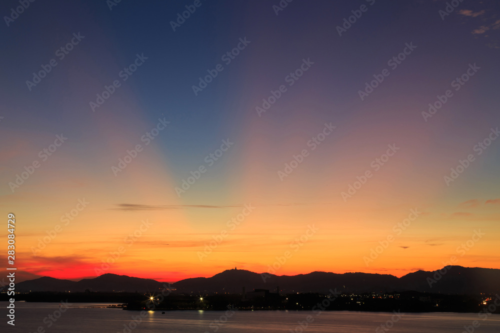 Vibrant and colorful purple sunset with silhouette of mountains/Colorful sunset behind mountains of tropical island/Sky after sunset a beautiful colorful/Beautiful twilight sky and landscape/