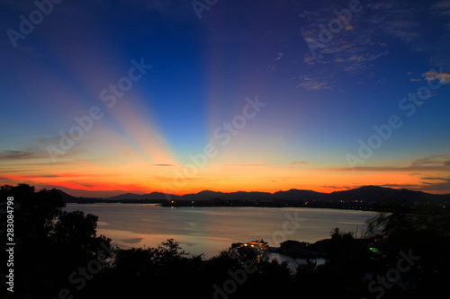 Vibrant and colorful purple sunset with silhouette of mountains/Colorful sunset behind mountains of tropical island/Sky after sunset a beautiful colorful/Beautiful twilight sky and landscape/