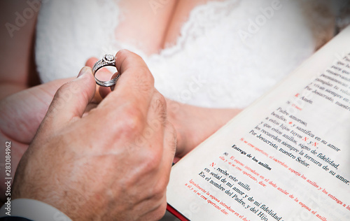 boyfriend reading the delivery of the engagement ring in religious ceremony to his future wife