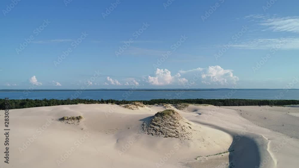 Aerial view of sand dunes Wydma Lacka in Slowinski National Park, natural shore of Baltic Sea, sunny summer day with blue sky - landscape panorama of Poland from above, Europe Aerial view of sand dunes Wydma Lacka in Slowinski National Park, natural shore of Baltic Sea, sunny summer day with blue sky - landscape panorama of Poland from above, Europe