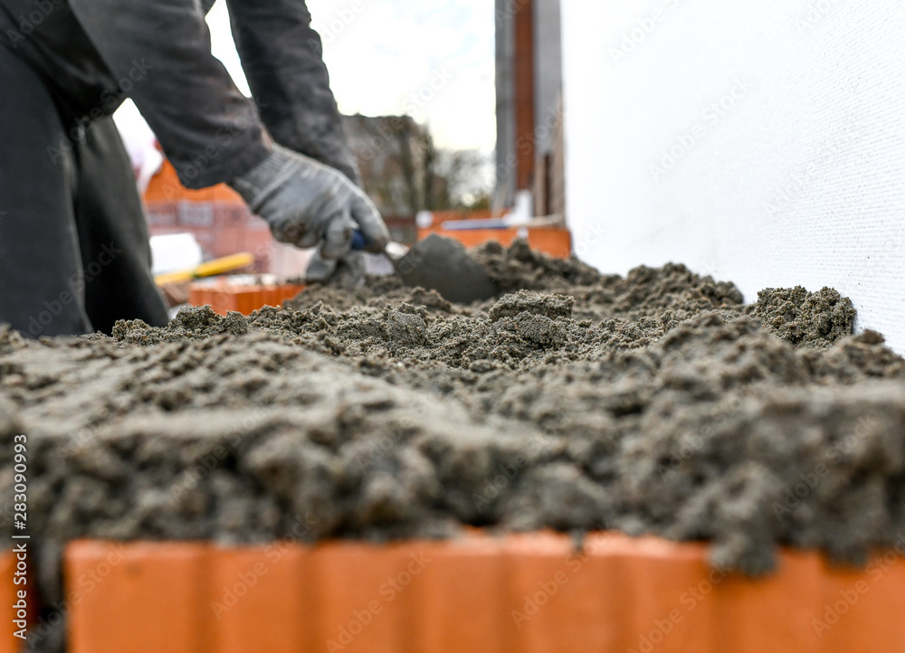 Naklejka premium construction brick concrete building worker