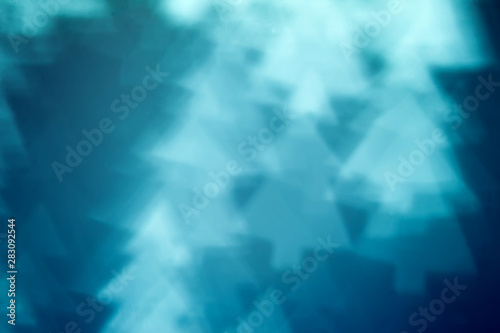 Blurred blue background with bokeh in the shape of fir tree. Abstract texture with soft focus