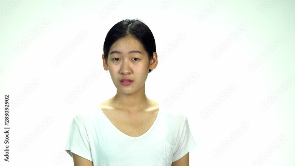 Young Asian 20s Woman black wrapped hair without cosmetic make up or fresh face look in t-shirt express emotion angry on white background for viral clip Casting or advertising Young Asian 20s Woman black wrapped hair without cosmetic make up or fresh face look in t-shirt express emotion angry on white background for viral clip Casting or advertising
