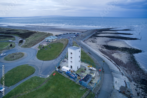 large white building near to rocks and the sea