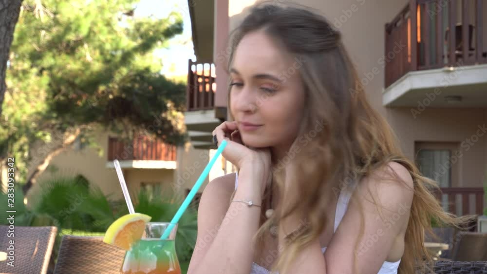 Beautiful girl drinks a rainbow cocktail. Resting by the pool and walking along the beach in Turkey Beautiful girl drinks a rainbow cocktail. Resting by the pool and walking along the beach in Turkey