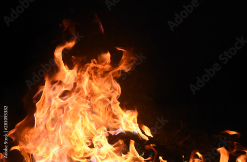 Fire with yellow and orange flames on black background