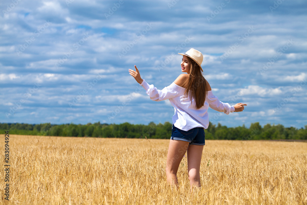 Young brunette woman in white shirt and blue jeans shorts Young brunette woman in white shirt and blue jeans shorts