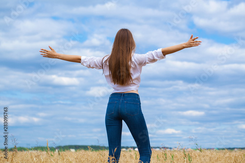 Young brunette woman in white shirt and blue jeans