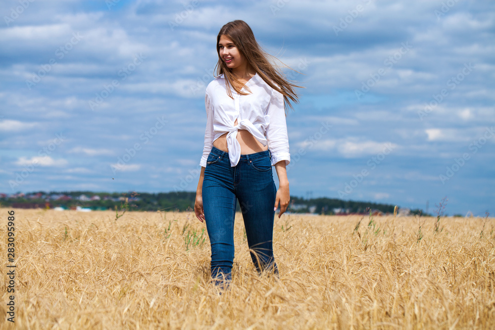 Young brunette woman in white shirt and blue jeans shorts Young brunette woman in white shirt and blue jeans shorts