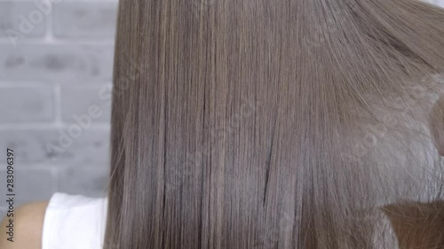 Result after lamination and hair straightening in a beauty salon for a girl with brown hair. hair care concept
