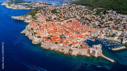 Dobrovnik, Croatia from above. Aerial drone footage of the historic city of Dubrovnik. City walls, blue sea and harbour.