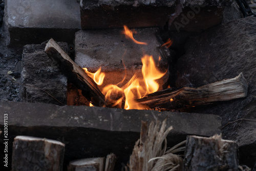 Burning fire in a campfire for cooking on a fire on a summer evening. Travel and tourism as a lifestyle