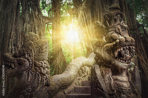 Ancient dragon sculptures on the bridge in monkey forest, Ubud, Bali, Indonesia photo