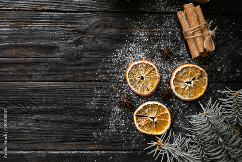festive christmas background, orange lies on the table, fragrant spices anise and cinnamon