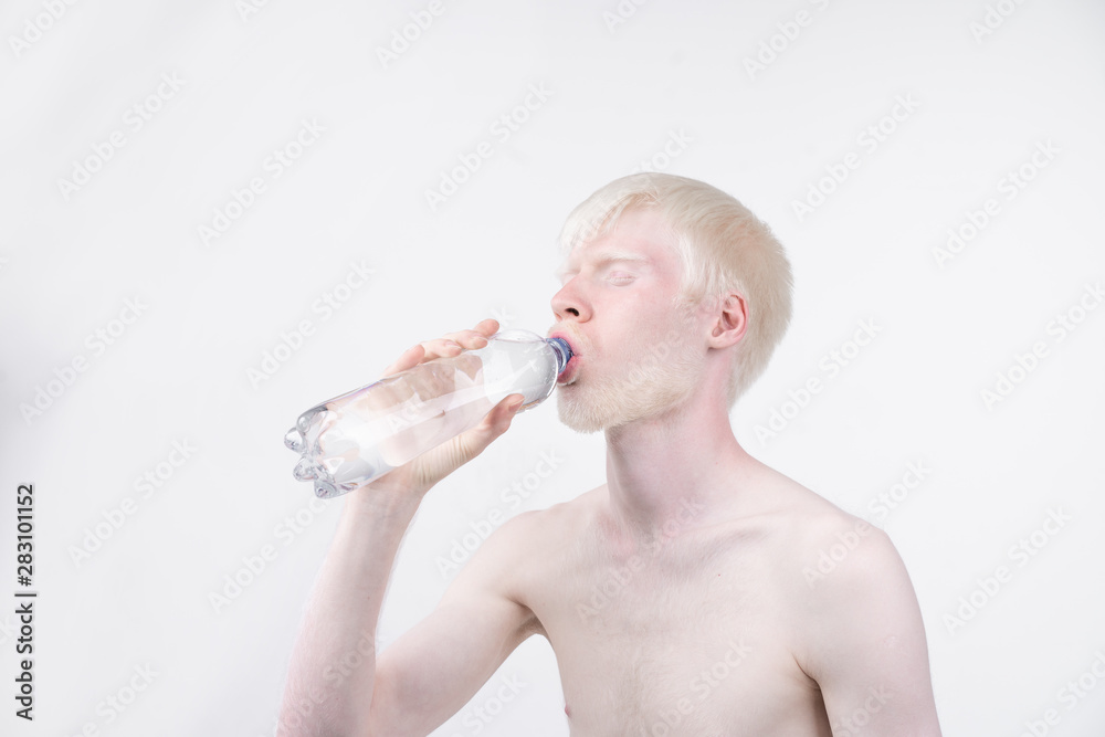 portrait of an albino man in studio dressed t-shirt isolated on a white background. abnormal deviations. unusual appearance portrait of an albino man in studio dressed t-shirt isolated on a white background. abnormal deviations. unusual appearance