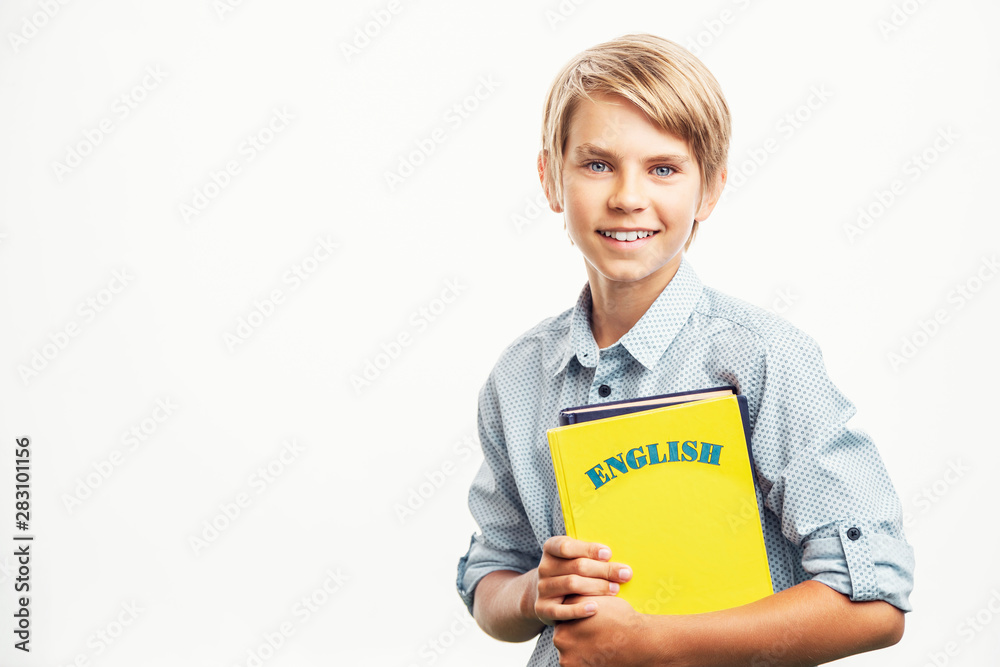 Smiling boy with English textbooks looks eager to study Smiling boy with English textbooks looks eager to study