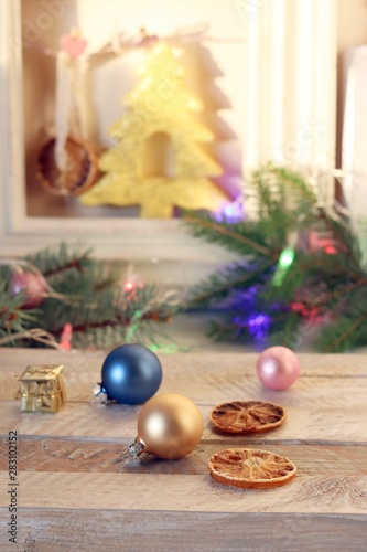 Decor, illuminated Christmas tree, Christmas toys and slices of dried lemon on a wooden table, seasonal winter holidays