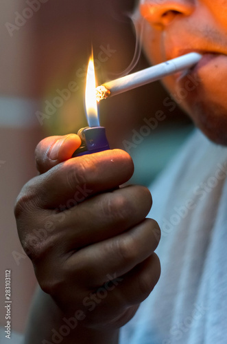 Man lighting up cigarette