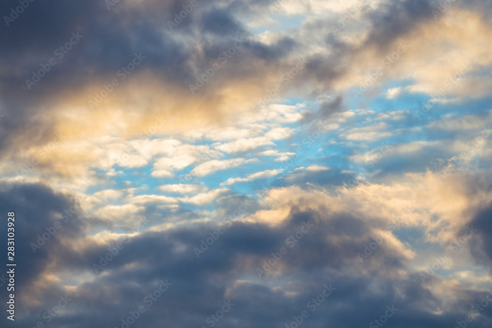 Blue sky among dark clouds. Cloudy landscape