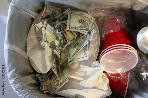 money in the trash can