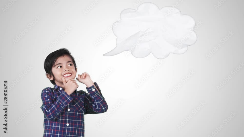 Cute little boy thinking idea while pointing at empty speech bubble, isolated on white background. Shot in 4k resolution Cute little boy thinking idea while pointing at empty speech bubble, isolated on white background. Shot in 4k resolution