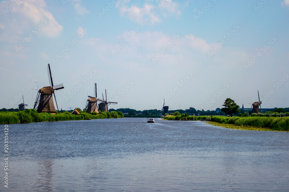 Traditional Dutch windmills scattered around the canals in Kinderdijk, Netherlands.