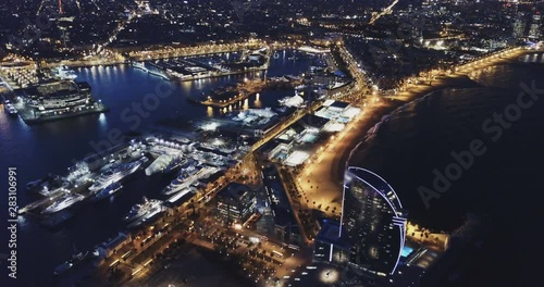  View from drone of illuminated Barceloneta beach with Port Vell  t night photo