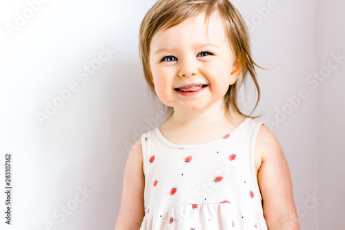 Happy smiling funny toddler child girl on white background