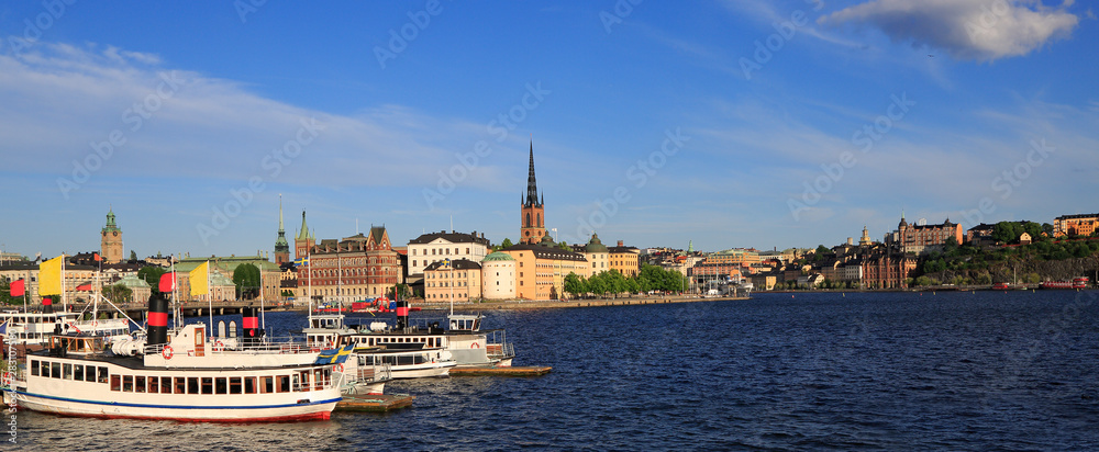 Scenic panoramic view of Stockholm's Old Town (Gamla Stan) late afternoon with a passenger ship on the foreground, Sweden