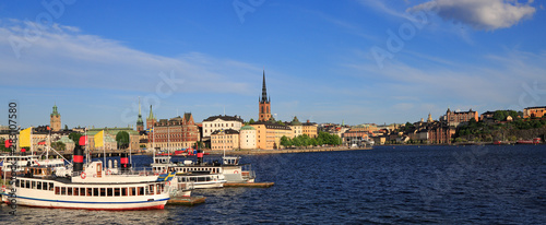 Scenic panoramic view of Stockholm's Old Town (Gamla Stan) late afternoon with a passenger ship on the foreground, Sweden