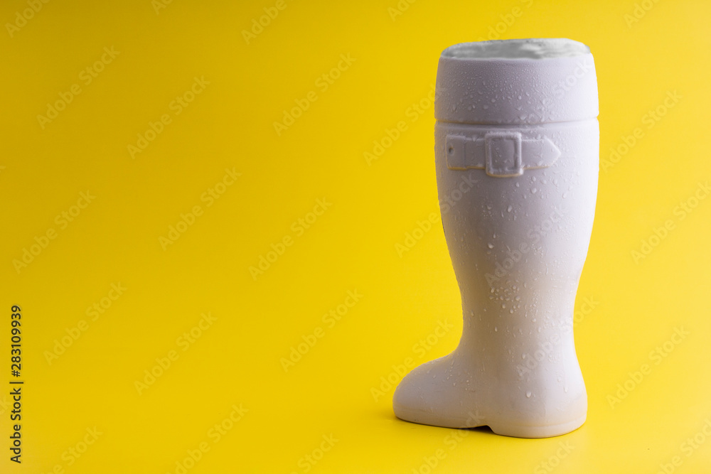 Vertical White Beer boot on a yellow Background Vertical White Beer boot on a yellow Background