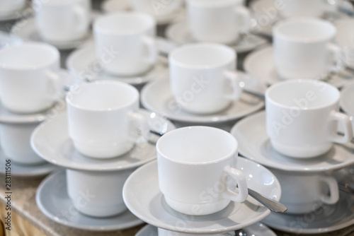 Serving white porcelain coffee and tea cups with saucer