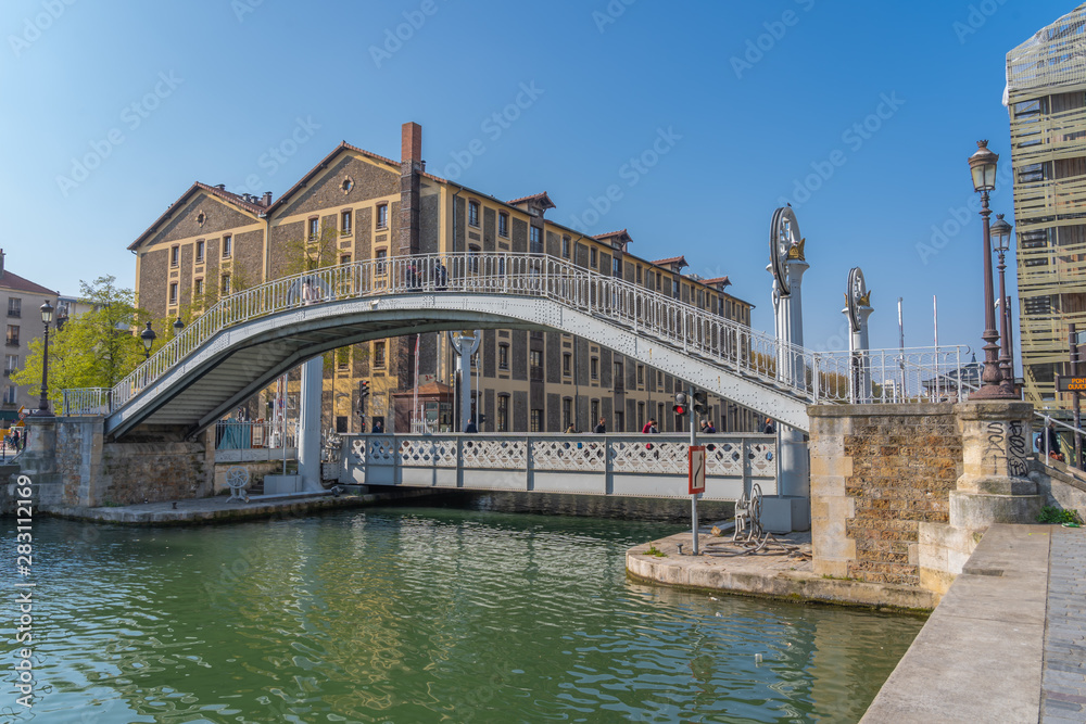 Fototapeta premium Paris, France - 04 14 2019: Canal Lourcq. Bridge of Flanders