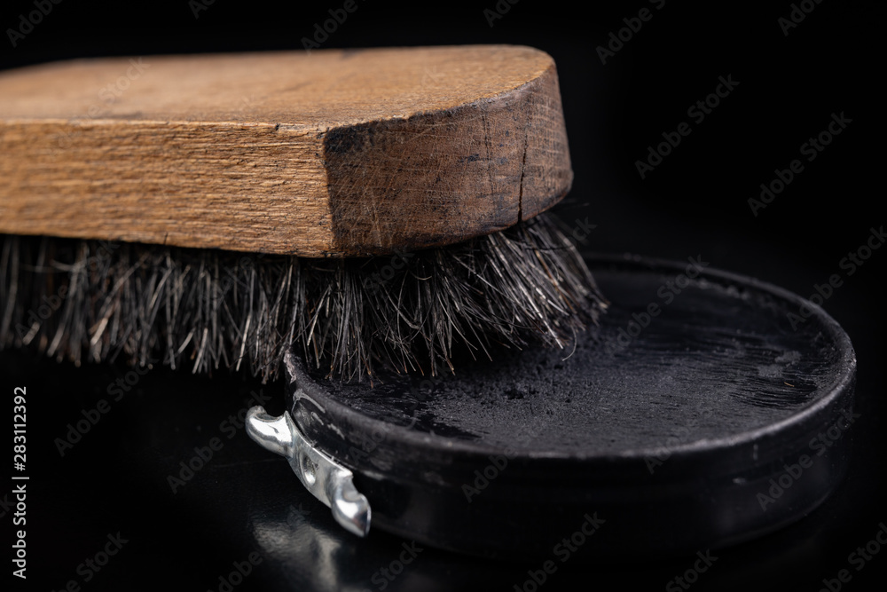 Black shoe polish, brush and shoes on the table. Accessories for cleaning  leather footwear. Stock Photo | Adobe Stock