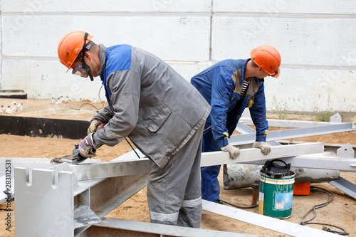 Locksmith performs stripping of metal structures for subsequent assembly photo