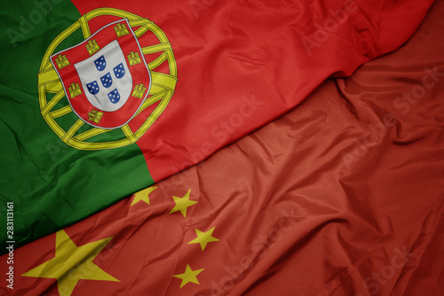 Canvas Print waving colorful flag of china and national flag of portugal.