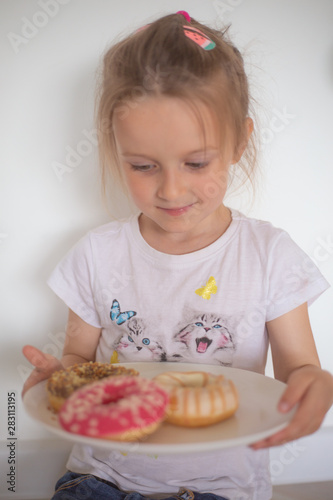 little girl eating doughnut