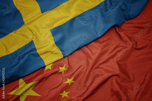 Photography waving colorful flag of china and national flag of sweden.