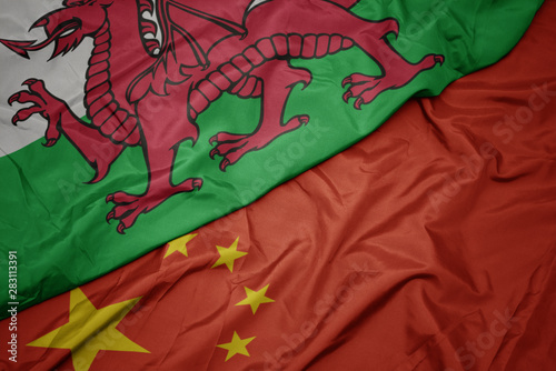 Photography waving colorful flag of china and national flag of wales.