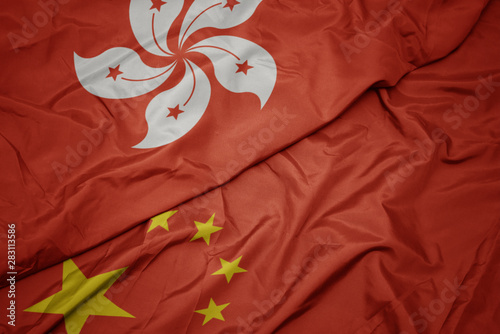 Photography waving colorful flag of china and national flag of hong kong.
