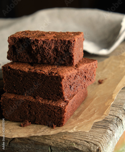 stack of baked square pieces of chocolate brownie cake