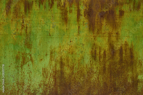 Rusted green painted metal wall. The metal surface rusted spots. Rysty corrosion.