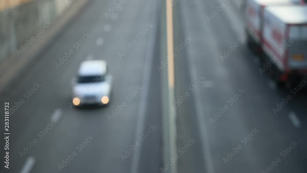 view of urban car traffic early in the morning, defocus makes beautiful bokeh from the included headlights, general plan view of urban car traffic early in the morning, defocus makes beautiful bokeh from the included headlights, general plan