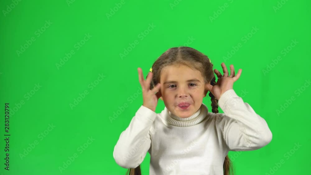 Child playing and make funny face, show tongue out on green screen Child playing and make funny face, show tongue out on green screen